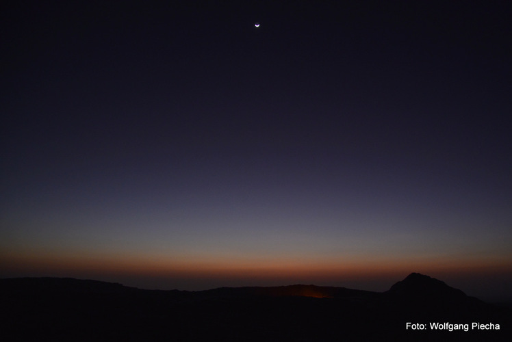 new moon over Erta Ale's magma lake, minutes before sunrise