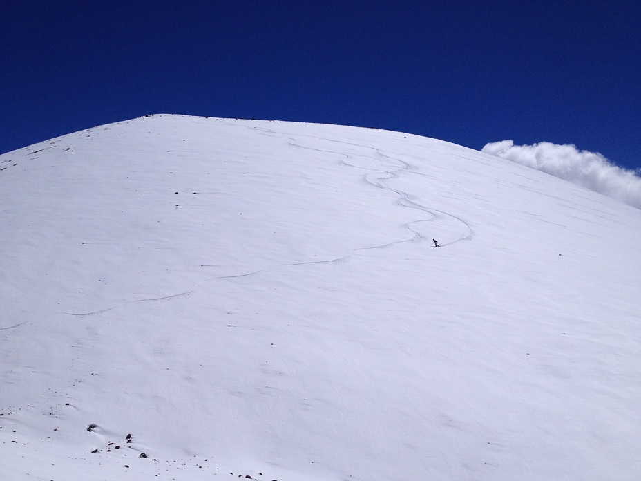 Snow surfing a cone near the summit, Mauna Kea