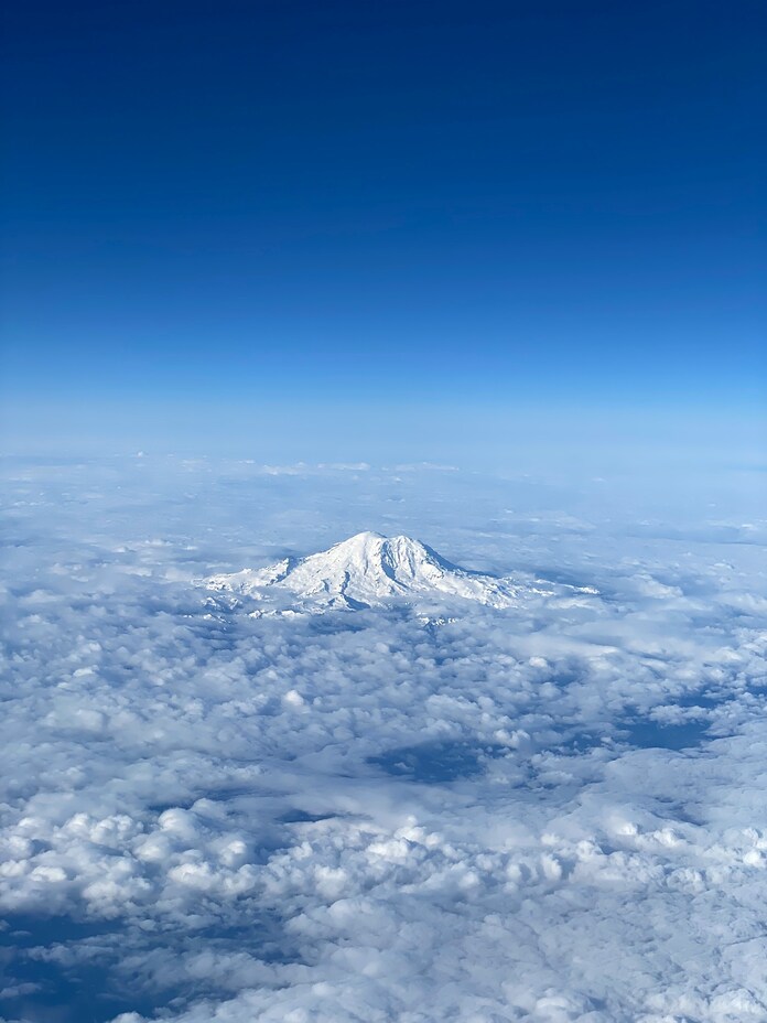 Aerial View of Mount Rainier Above the Clouds