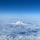 Aerial View of Mount Rainier Above the Clouds